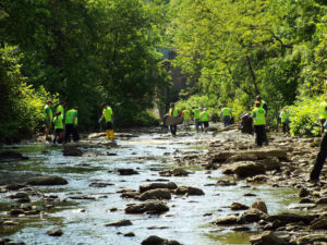 volunteers cleaning up a stream