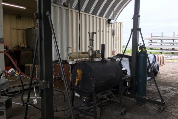 Indirect thermal desorption/thermal oxidation technology pilot study scale setup including a small boiler located in a large metal shed in Robstown Texas