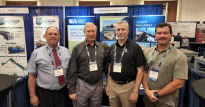 Paper authors Don Hayes, Mike Palermo, Matt Bowman, and Jamie Beaver stand together at the EA exhibit during the Western Dredging Association’s 2022 summit and expo.