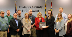 EA’s Beth Schrayshuen joins the Frederick County in accepting Cartegraph’s High Performance Operations Award
