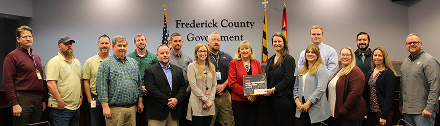 EA’s Beth Schrayshuen joins the Frederick County in accepting Cartegraph’s High Performance Operations Award