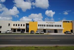 White and Yellow Brick two storry office building with roadway in the foreground