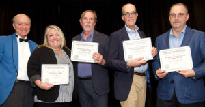 Grant Ferrier of Environmental Business International joins Abbie Smith, Fritz Meyer, Dick Waterman, and Paul Caprio, who accepted and are holding EA’s EBJ Awards.