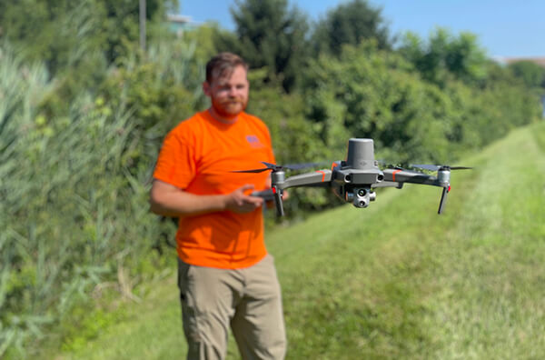 Drone pilot with thermal drone in flight