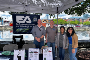 Four EA employees standing together at EA’s table at the 2024 big truck day.