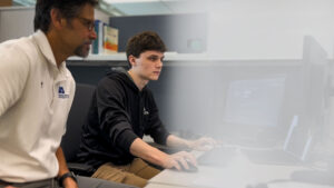 Two EA employees working together in a cubical