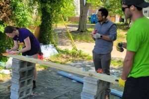 Image of volunteers working on tool shed.