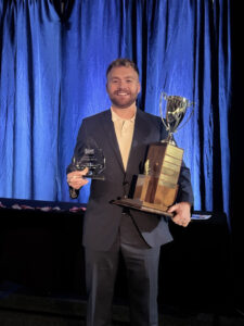 EA Pacific Northwest Operations Manager Garrett Lee. holding both the awards