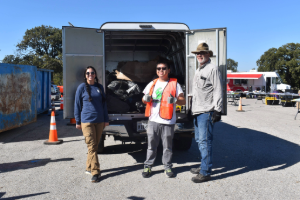 EA staff participating in the KLB Trinity Trash Bash event standing in front of the trash collected