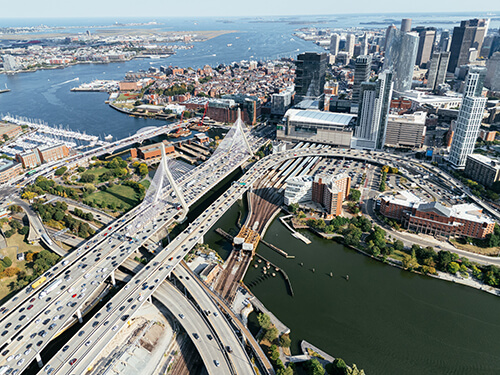 Aerial view of Boston with major roadways and bridges in the foreground