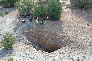 Aerial of the shaft opening at the Schmitt Decline Mine with scientists in the background collecting soil samples.