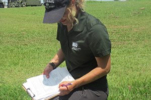 A scientists looks at a document in the field