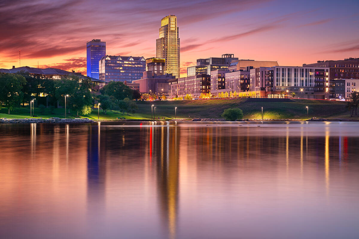 Omaha, Nebraska city skyline with a river in the foreground snaking toward the downtown area